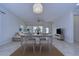 Open-concept dining area with white table, stylish chairs, and natural light at 19462 Paddock View Dr, Tampa, FL 33647