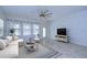 Bright living room with a ceiling fan, comfortable seating, and tile flooring at 19462 Paddock View Dr, Tampa, FL 33647