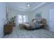 Serene main bedroom featuring tray ceiling, ample natural light, and coastal decor at 19462 Paddock View Dr, Tampa, FL 33647