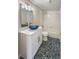 Modern bathroom featuring unique pebble-tile floors, a sleek vanity, and shower-tub combo at 26933 Carmen Pl, Lutz, FL 33559