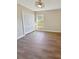Bedroom with new wood floors, closet, window at 26933 Carmen Pl, Lutz, FL 33559
