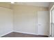 Bedroom with neutral paint, wood-look floors, baseboards, and window at 26933 Carmen Pl, Lutz, FL 33559