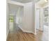 Hallway with wood-look flooring leading to various rooms within the house at 26933 Carmen Pl, Lutz, FL 33559