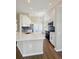 Bright kitchen with white cabinets, quartz countertops, stainless steel appliances and modern lighting at 26933 Carmen Pl, Lutz, FL 33559