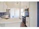 Stylish modern kitchen featuring a quartz island, white cabinets, black appliances and gold accents at 26933 Carmen Pl, Lutz, FL 33559