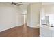 Open-concept living space with high ceilings, wood-look flooring, and modern finishes flowing into the kitchen at 26933 Carmen Pl, Lutz, FL 33559