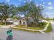 Corner lot home with mature trees and front yard landscaping at 26933 Carmen Pl, Lutz, FL 33559