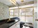 Cozy bathroom featuring a black marble vanity and a glass enclosed shower, with checkered tile flooring at 2989 Brookfield Ln, Clearwater, FL 33761