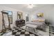 Bright bedroom with a modern design featuring a checkered floor, a comfortable bed, and natural light at 2989 Brookfield Ln, Clearwater, FL 33761