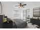 Comfortable bedroom featuring a large bed, mirrored closet doors, and stylish decor with a ceiling fan at 2989 Brookfield Ln, Clearwater, FL 33761