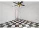 Bright bedroom features checkered flooring, a ceiling fan, and an open doorway at 2989 Brookfield Ln, Clearwater, FL 33761