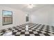 Well-lit bedroom showcasing its checkered tile flooring and bright windows at 2989 Brookfield Ln, Clearwater, FL 33761