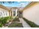 Inviting entryway to the home with a walkway lined with greenery at 2989 Brookfield Ln, Clearwater, FL 33761