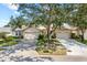 Attractive exterior of a single-story home with a two-car garage and lush landscaping at 2989 Brookfield Ln, Clearwater, FL 33761