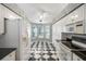 White kitchen with ample cabinet space, black countertops, and a breakfast nook at 2989 Brookfield Ln, Clearwater, FL 33761