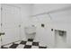 Laundry room with utility sink, shelving and checkerboard floor at 2989 Brookfield Ln, Clearwater, FL 33761