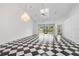 Bright living room featuring a fireplace and a checkerboard tile floor at 2989 Brookfield Ln, Clearwater, FL 33761