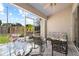 Relaxing screened-in patio with comfortable seating and serene views of the landscaped backyard at 2989 Brookfield Ln, Clearwater, FL 33761
