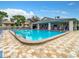 Community pool with lounge chairs and patio tables at 2989 Brookfield Ln, Clearwater, FL 33761