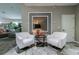 Elegant sitting area with two white armchairs and a side table at 2989 Brookfield Ln, Clearwater, FL 33761