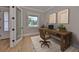 Well-lit home office features a neutral color palette, stylish wooden desk, and modern decor at 3812 W Sevilla St, Tampa, FL 33629