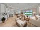 Bright open-concept living room shows views of the backyard, contemporary furniture and hardwood floors at 3812 W Sevilla St, Tampa, FL 33629