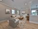 Comfortable living room is furnished with a sofa, armchairs, decorative artwork and hardwood floors at 3812 W Sevilla St, Tampa, FL 33629