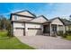 Charming two-story home with a three-car garage, covered porch, and well-maintained landscaping at 4656 Southern Valley Loop, Brooksville, FL 34601