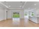 Spacious living area with wood floors, sliding glass doors and kitchen access at 4656 Southern Valley Loop, Brooksville, FL 34601
