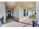 Cozy covered porch with brick accents, offering a welcoming entrance with black metal railings at 4656 Southern Valley Loop, Brooksville, FL 34601