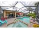 Resort-style pool and spa with covered patio and outdoor kitchen at 921 Regal Manor Way, Sun City Center, FL 33573