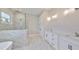 Elegant bathroom with marble shower, soaking tub, and double vanity at 3812 W Sevilla St, Tampa, FL 33629
