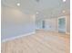 Bright bonus room featuring hardwood floors and multiple doors at 3812 W Sevilla St, Tampa, FL 33629