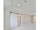 Spacious bedroom with carpeted floor, barn door, and recessed lighting at 3812 W Sevilla St, Tampa, FL 33629