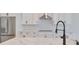 Modern kitchen with white cabinets, stainless steel appliances, and marble countertops at 3812 W Sevilla St, Tampa, FL 33629