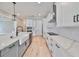 Kitchen with white cabinets, marble countertops, and farmhouse sink at 3812 W Sevilla St, Tampa, FL 33629