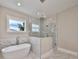 Spa-like bathroom with soaking tub, marble shower, and window at 3812 W Sevilla St, Tampa, FL 33629