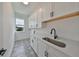 Laundry room with white cabinets, patterned floor and a window at 3812 W Sevilla St, Tampa, FL 33629
