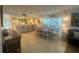 Charming dining area with a rustic wooden table and white chairs, adjacent to the kitchen at 7530 Palm Island S Dr # 1413, Placida, FL 33946