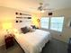 King-size bed, decorative wall art, and ceiling fan at 7530 Palm Island S Dr # 1413, Placida, FL 33946