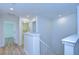 Upstairs hallway with access to bedrooms and laundry at 19462 Paddock View Dr, Tampa, FL 33647