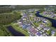 Aerial view of a neighborhood with houses and waterways at 19462 Paddock View Dr, Tampa, FL 33647