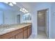 Double vanity bathroom with granite countertops and tiled floors at 19462 Paddock View Dr, Tampa, FL 33647