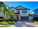 Two-story house with a gray garage door and attractive landscaping at 19462 Paddock View Dr, Tampa, FL 33647