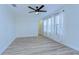 Bedroom with wood-look floors, ceiling fan and walk-in closet at 19462 Paddock View Dr, Tampa, FL 33647