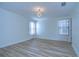 Bright bedroom with wood-look floors and chandelier at 19462 Paddock View Dr, Tampa, FL 33647