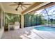 Outdoor kitchen with a built-in grill and mini-fridge, adjacent to the pool at 19462 Paddock View Dr, Tampa, FL 33647