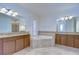 Large bathroom with corner tub, granite counters, and dual sinks at 19462 Paddock View Dr, Tampa, FL 33647