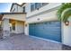 Two-car garage with a carriage-style door and paver driveway at 19462 Paddock View Dr, Tampa, FL 33647