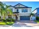 Two-story home with a paver driveway and lush landscaping at 19462 Paddock View Dr, Tampa, FL 33647